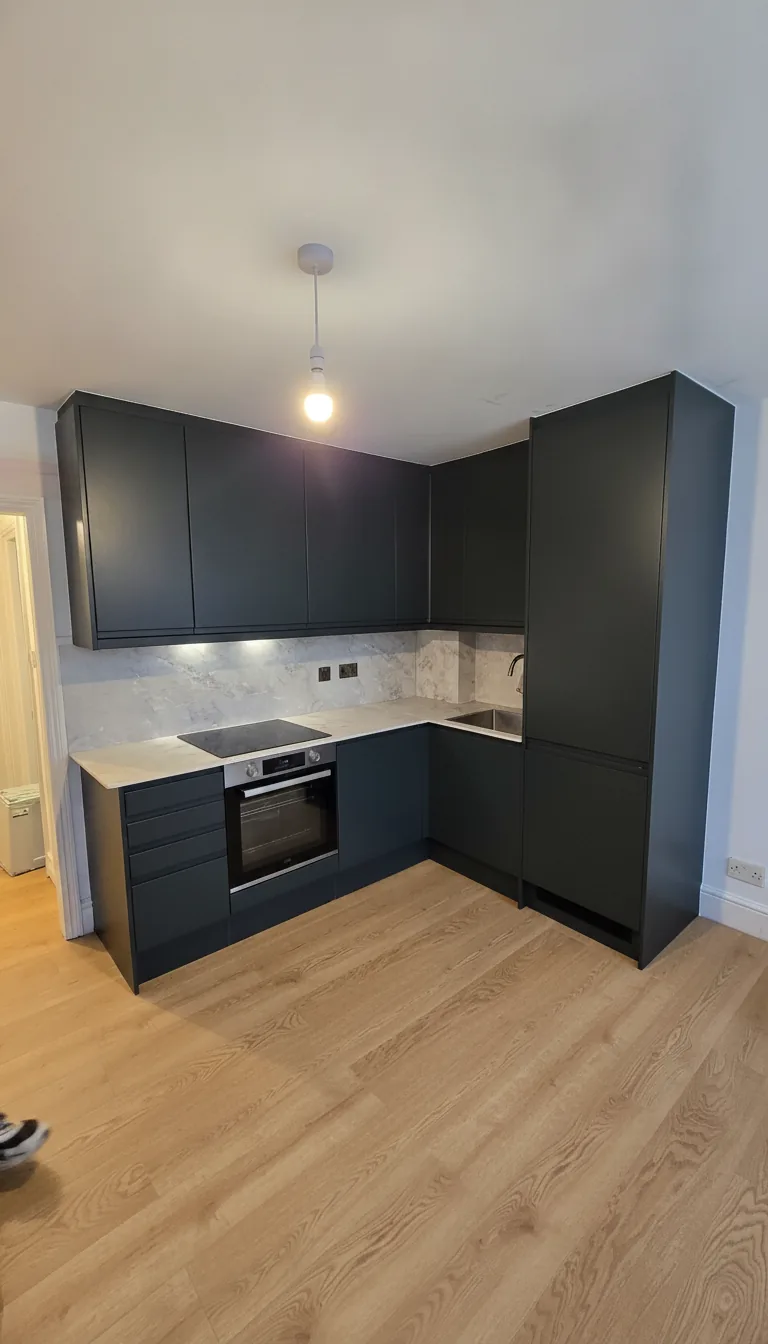 Dark green kitchen installation, North London