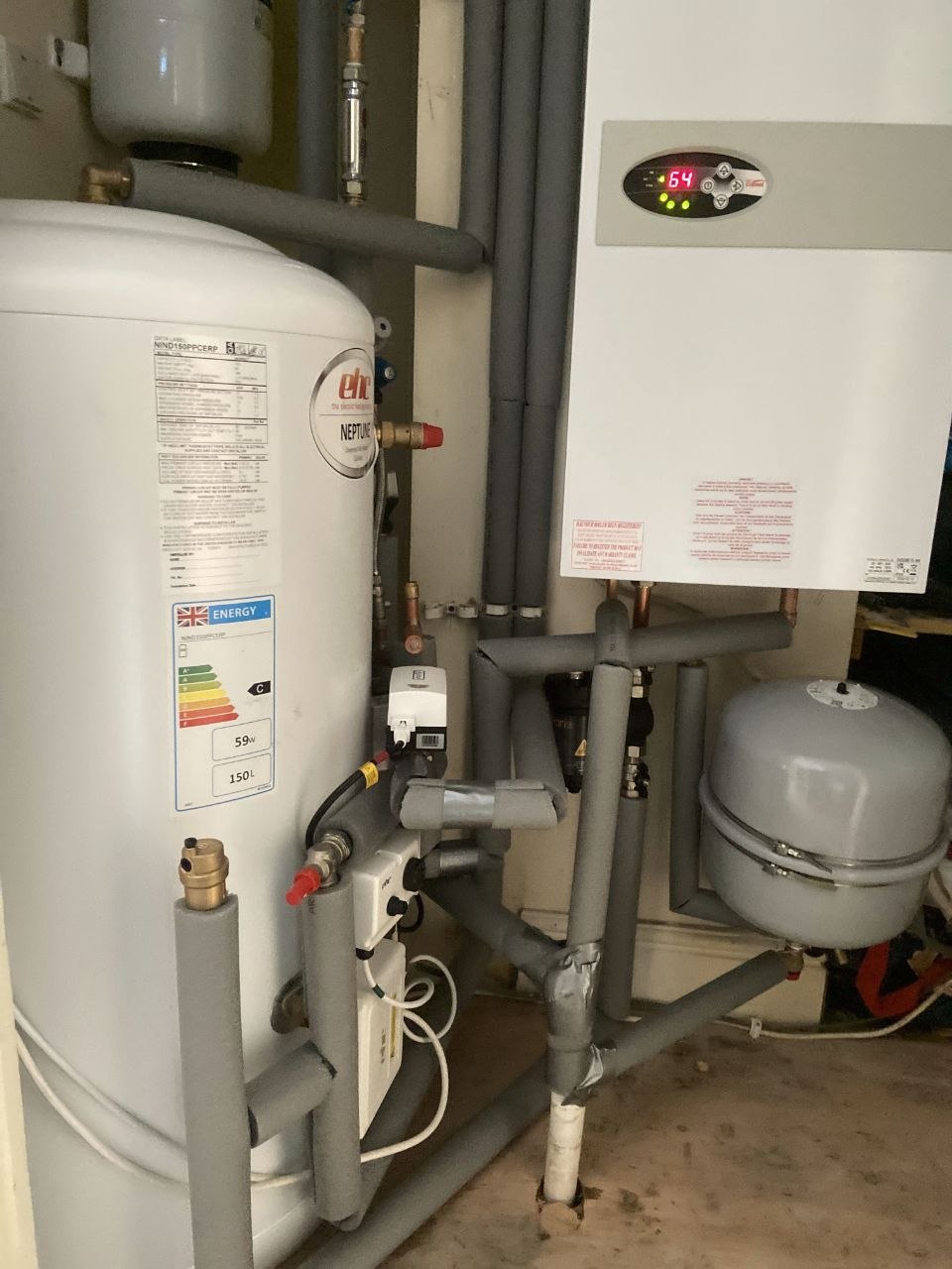 Installed EHC Neptune 150-litre hot water cylinder beside a wall-mounted boiler.